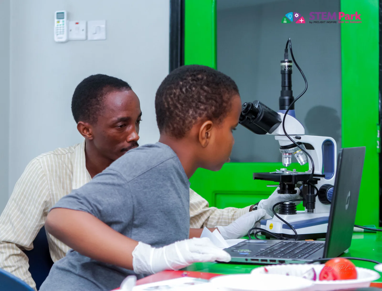 A learner exploring a microscope with one-to-one guidance during a private STEM session