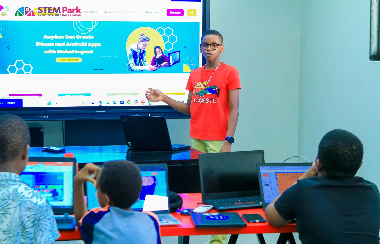A learner presenting to other children during Holiday Camp