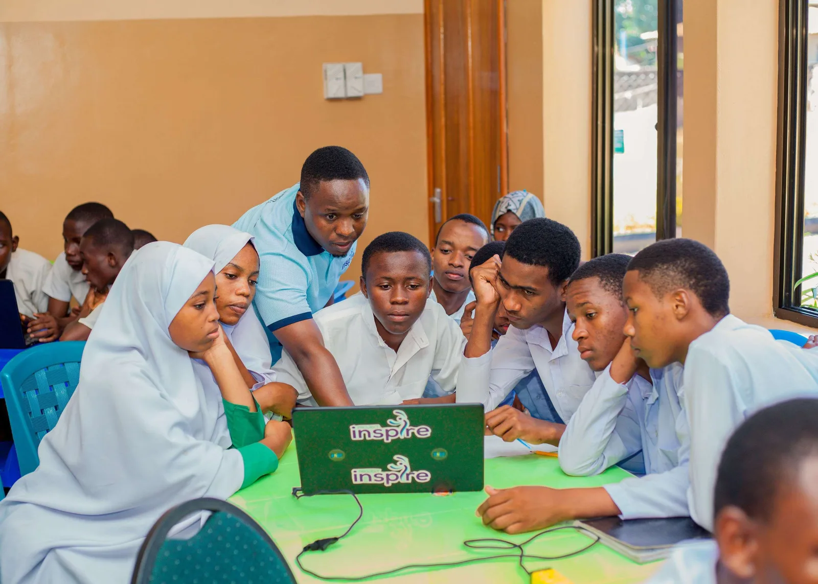 A facilitator guiding students through a STEM learning activity