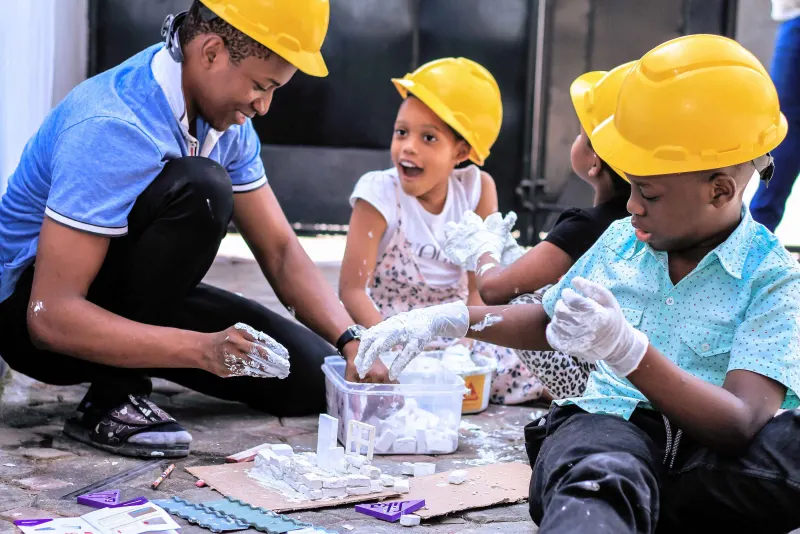 Children building a model together during a practical STEM activity